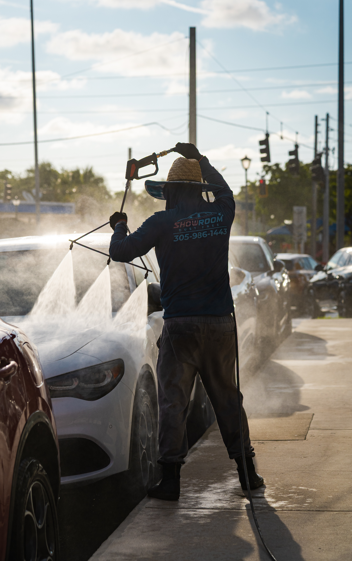 Treated water spray washing dealership vehicle