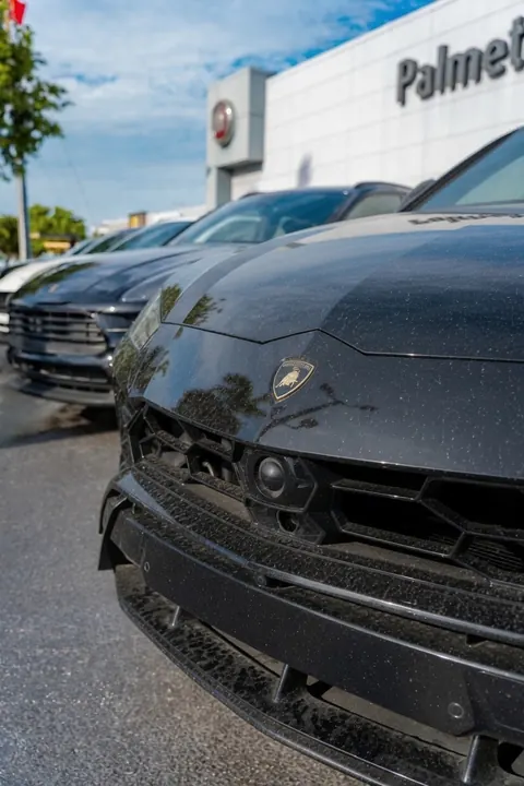 Showroom Dust Free Corp cleaning dealership vehicles in Miami